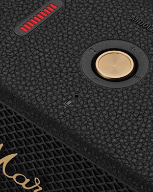 Close-up of the Marshall Middleton II Black and Brass portable Bluetooth speaker with a textured black finish, gold control knob, red LED indicator, and part of the Marshall logo visible at the bottom.