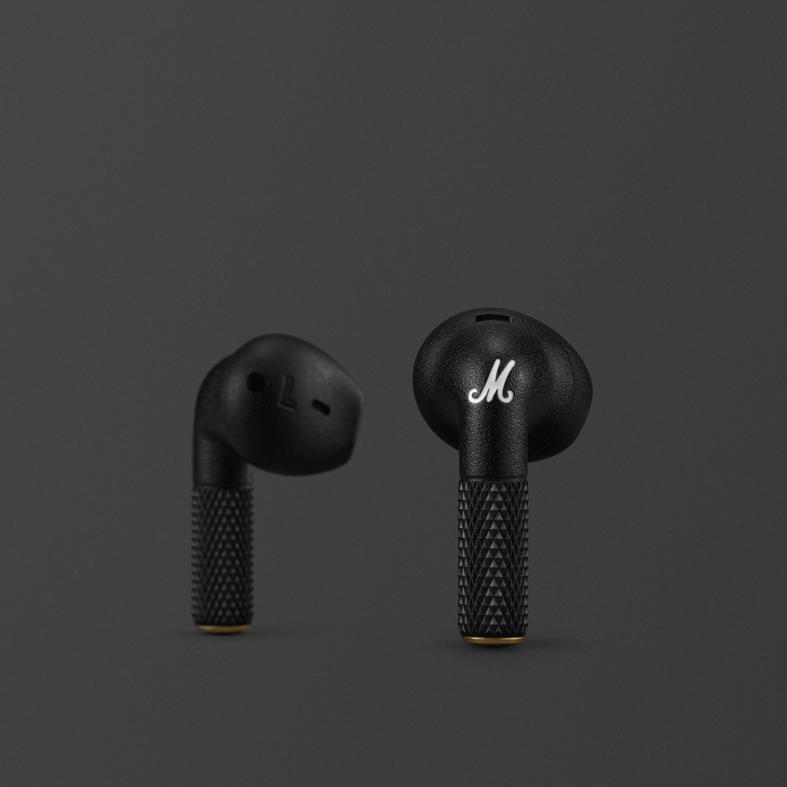 Minor IV Earbuds in black against a dark background.