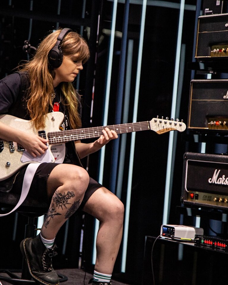 Debbie Gough playing guitar at NAMM