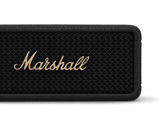 Close-up of the Marshall Emberton III Black and Brass portable speaker with a textured front grille and the brand logo in gold letters, featuring Bluetooth connectivity.