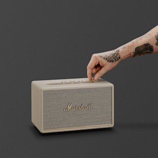 A Marshall Acton III Bluetooth home speaker in cream, shown on a dark grey background.
