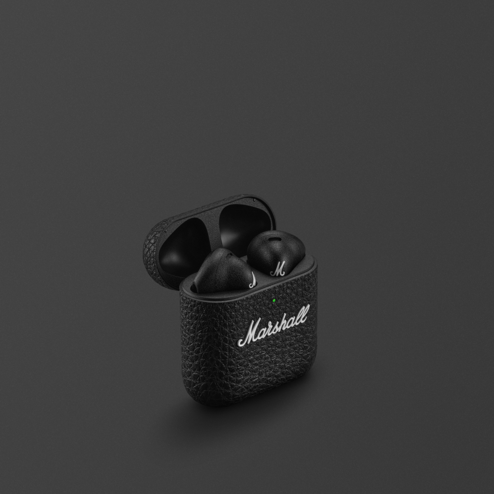 Marshall Minor IV Black wireless earbuds against a gray background.