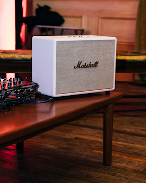 A Marshall white home speaker on a table