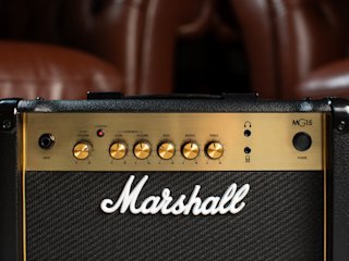 The Marshall MG15G Combo with leather sofas in the background.