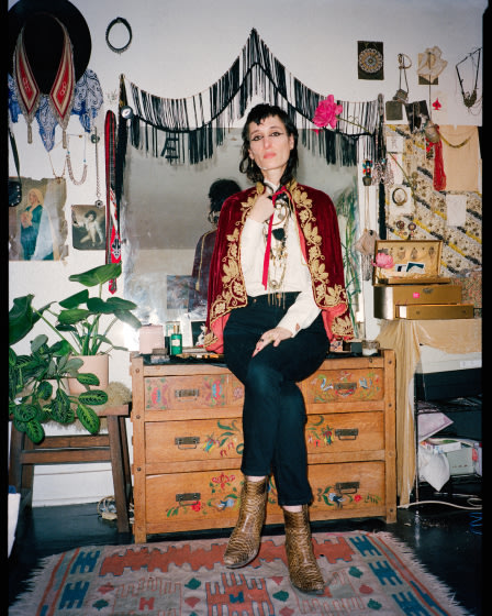 Zumi Rosow sitting on a dresser in a room.
