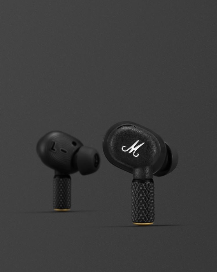 A pair of MOTIF II A.N.C. BLACK earphones with the letter m on them. (Marshall)