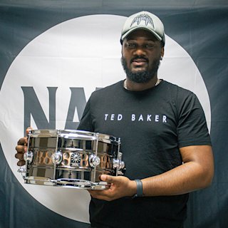 Myles Crossfield holding a Natal snare drum