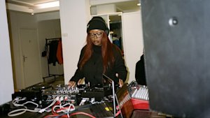 A woman DJ playing music.