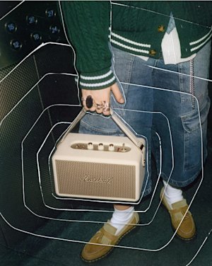 A person holds Kilburn III Cream portable speaker.