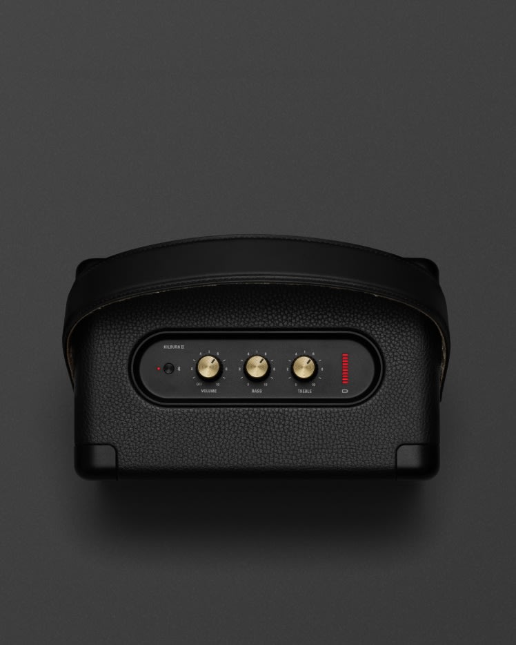 The Marshall Kilburn II Black and Brass is a portable speaker in black with a red button on it.