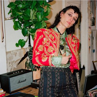 Zumi Rosow and a black Marshall speaker.