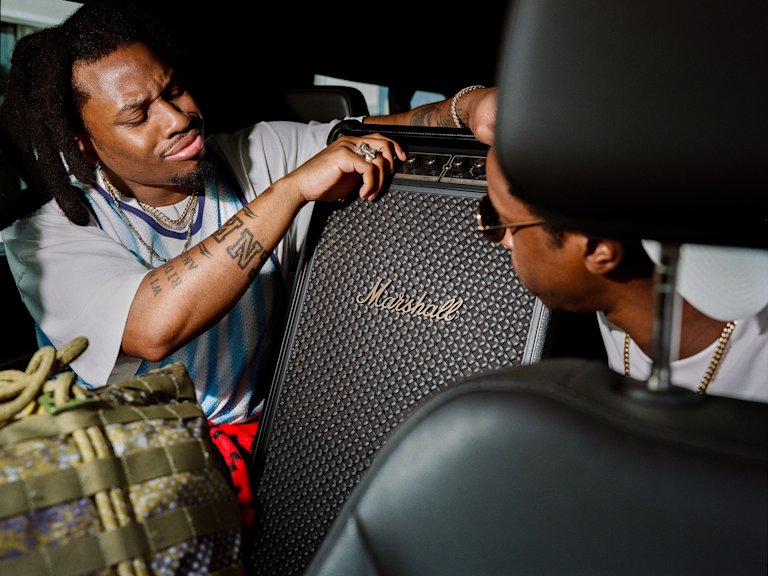 Denzel Curry adjusting the sound of Bromley, the party speaker by Marshall