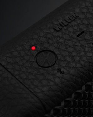 The bluetooth button on top of a Willen speaker.