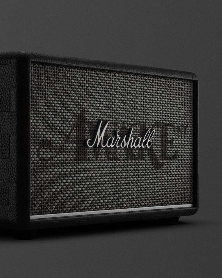 Marshall Acton III Awake NY bluetooth speaker, featuring a textured dark mesh front and white logo, is set against a dark background.