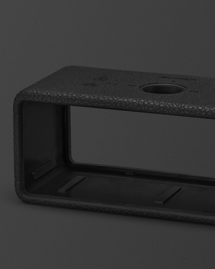 An Emberton II Sleeve Black, featuring a textured design, is shown against a dark background.