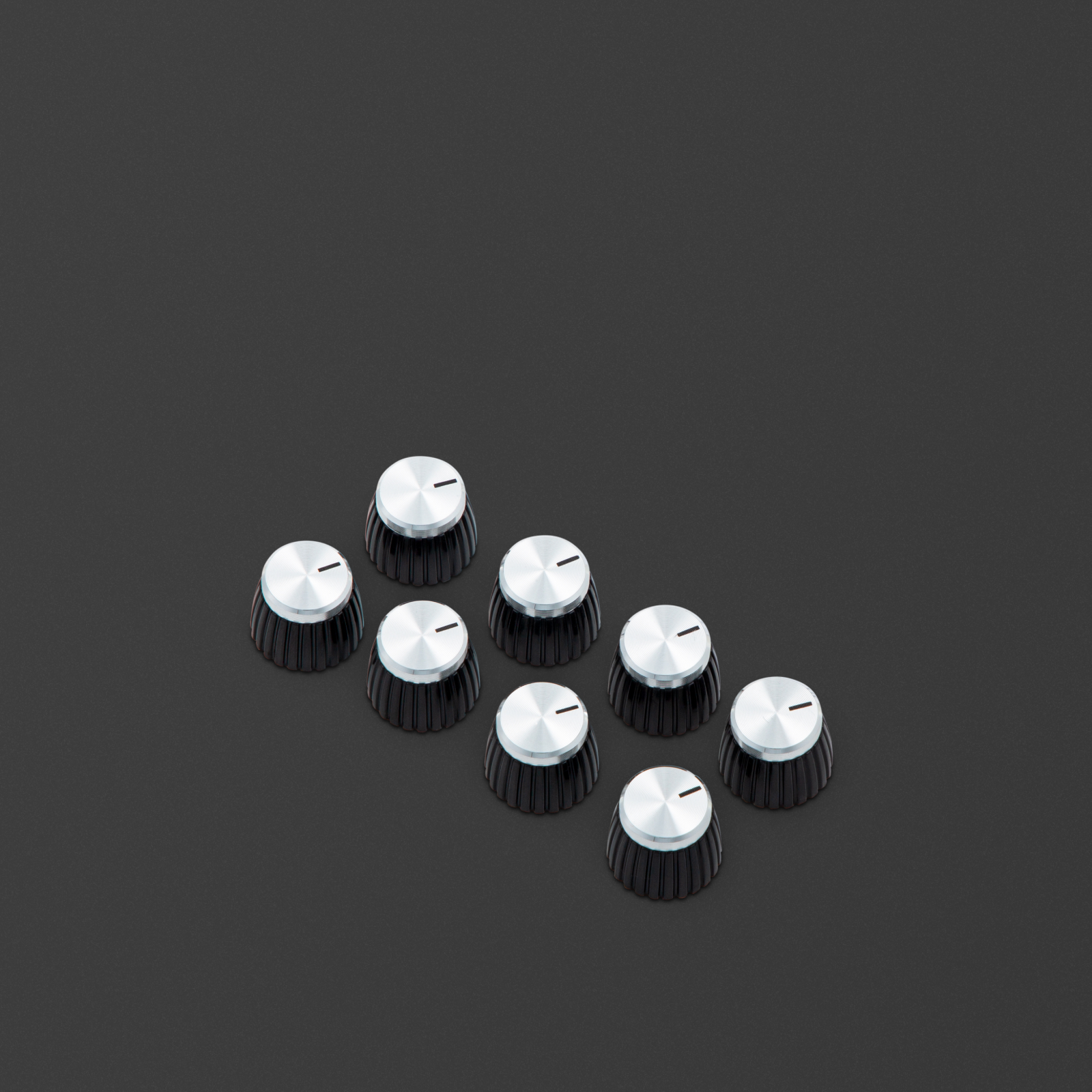 Knobs with a black body, silver cap, and have a D-shaped push-on profile.