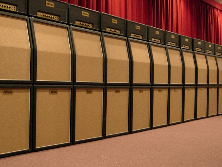 Imagen de una veintena de amplificadores de estudio Marshall alineados contra una pared