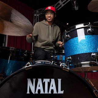 Nathan Greene playing on a Black and Blue Natal drum