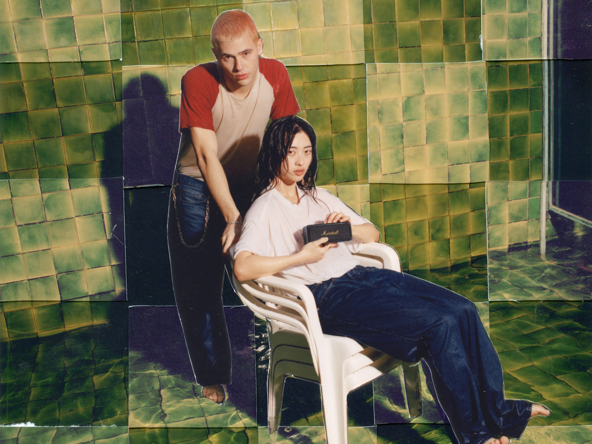 A girl sitting on a plastic chair holding a Marshall Emberton II Outdoor Speaker with her friend behind her