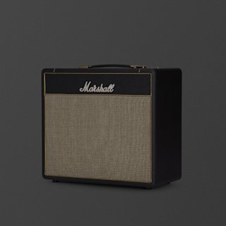A black Marshall Studio Vintage guitar amplifier with a woven speaker grille and brass trim, set against a plain dark background.