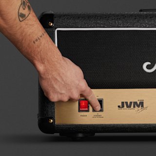 A person is pushing a button on Marshalls JVM210 Head