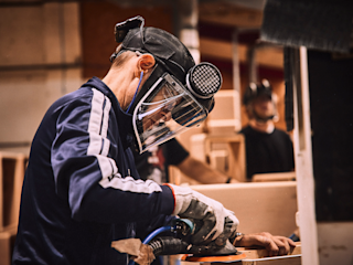 A worker from the UK factory wearing the security equipment whilst building a Marshall amplifier