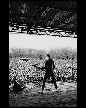 Paul Simonon from The Clash playing in front of a crowd at Rock Against Racism’s ‘Carnival Against the Nazis’ concert.