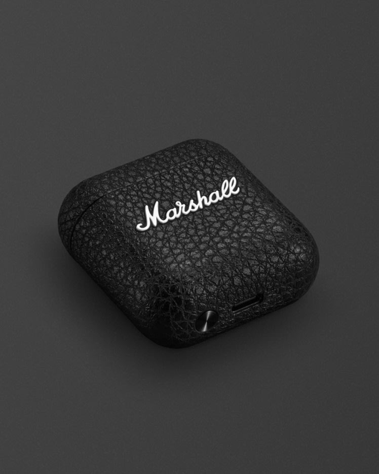 Marshall Minor IV Carging Case in Black laying on a dark background.