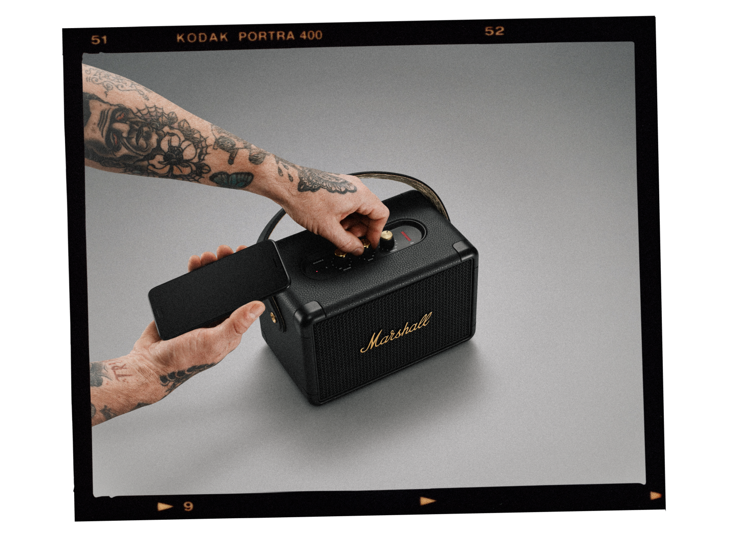 A man puts on a Marshall speaker.