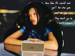 Suki leaning on a table with Marshall speaker