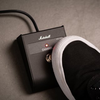 A shoe lies beside a Marshall DSL1 Head.