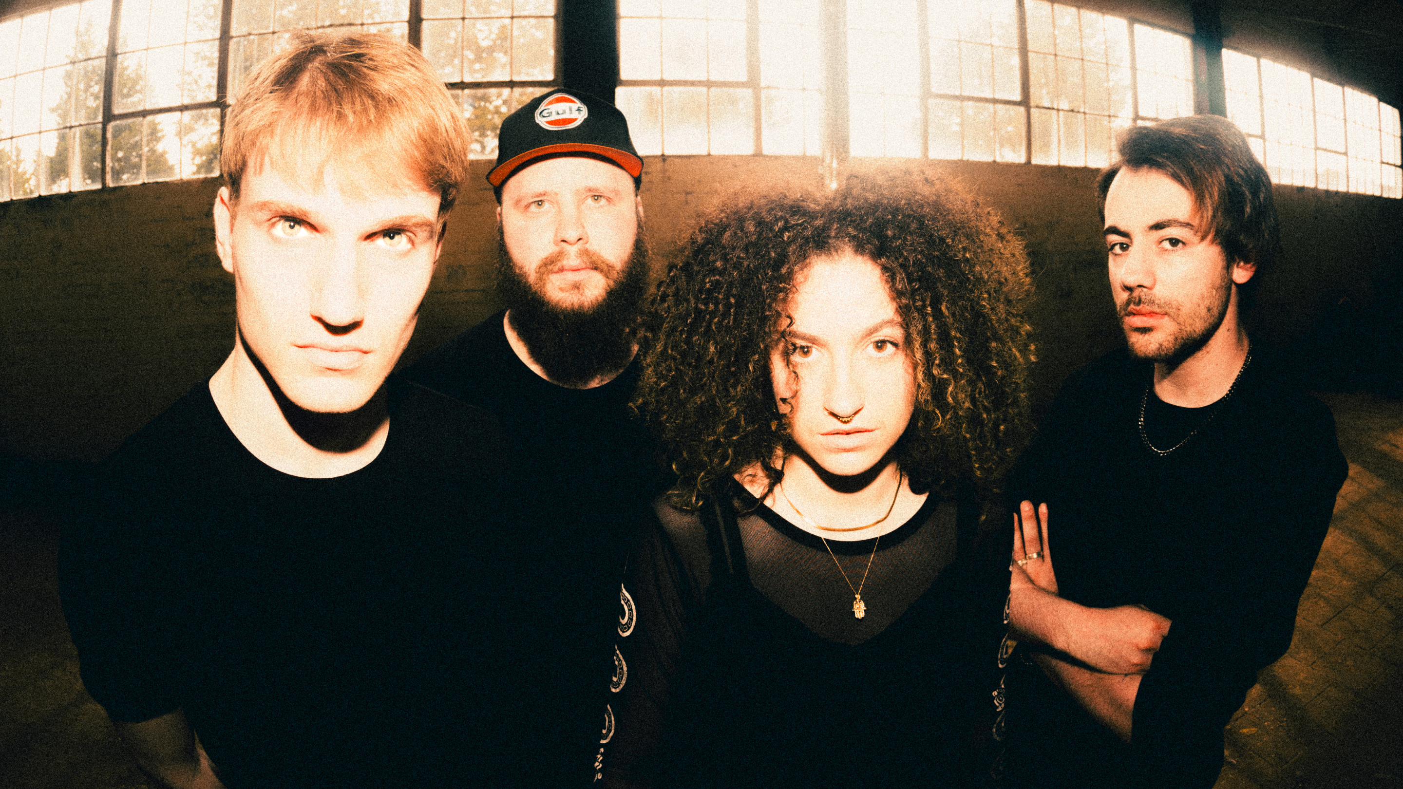 Mallavora band members photoshoot in a white and empty warehouse.