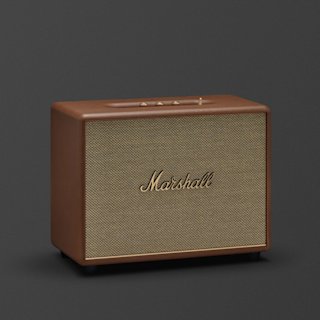 A brown Marshall Woburn III Bluetooth speaker with a brass logo and control knobs on top, placed against a plain dark background.
