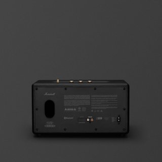 Rear view of a black Marshall Stanmore III Bluetooth speaker showing input ports, power socket, and product information labels on a dark background.