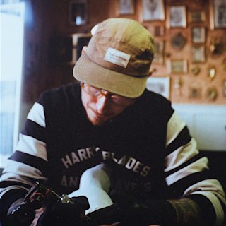 Un tatuador con gorra en el Welcome Studio.