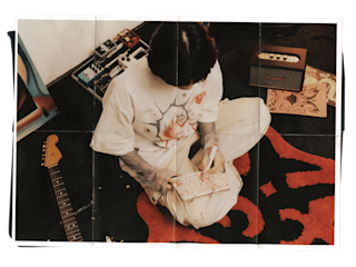 The illustrator Rindo sketching in a notebook.