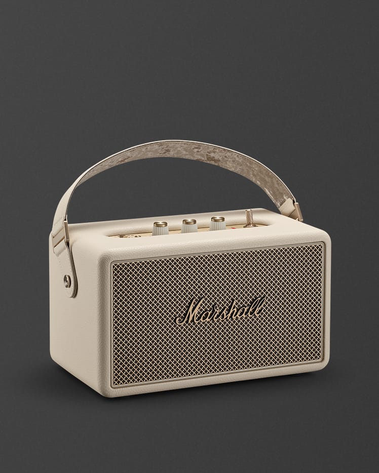 Marshall Kilburn III Cream portable bluetooth speaker, featuring a carrying strap and top-mounted control knobs.