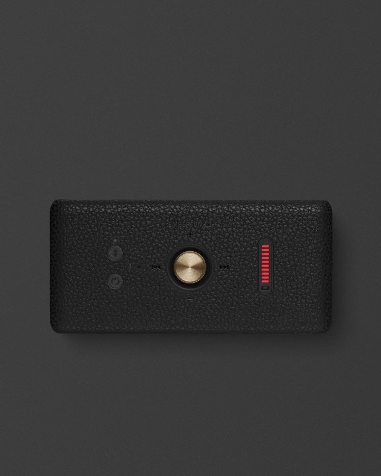 Marshall Emberton III Black and Brass speaker featuring a central golden knob and a vertical red LED display on the right.