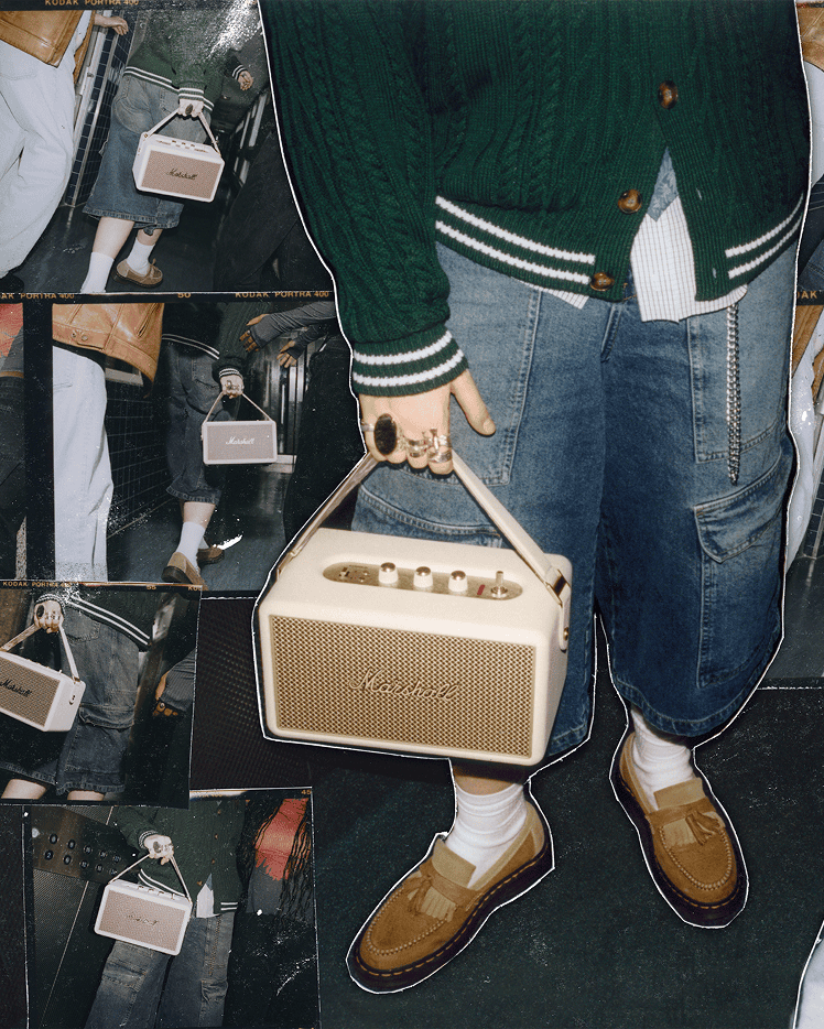 A person holds the Marshall Kilburn III Cream portable speaker.