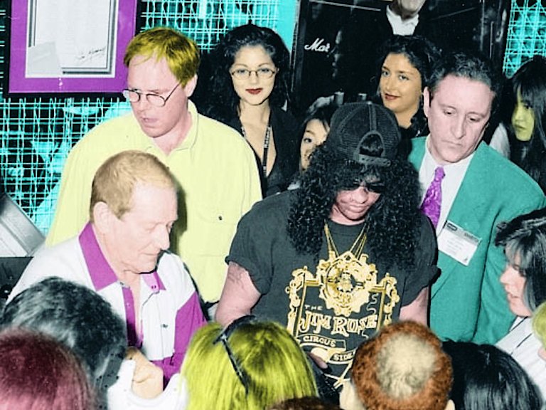 Slash walking through a crowd of people with Jim Marshall