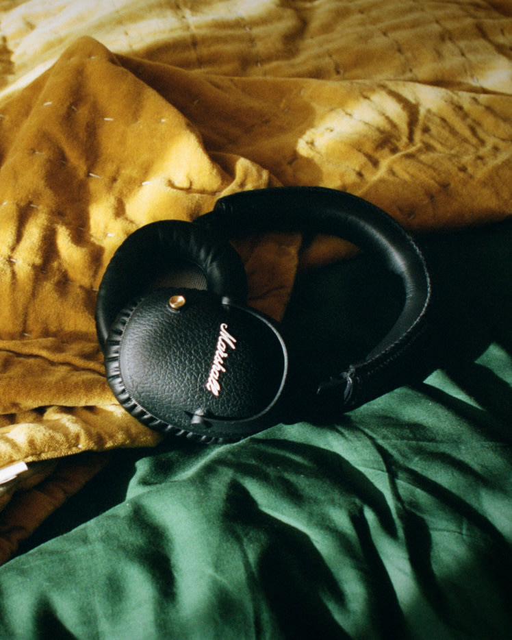 Marshall Monitor II A.N.C. Black Headphones placed on top of a green and yellow bed sheet