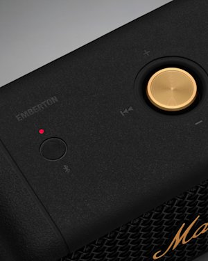 The Bluetooth button and Control knob on top of an Emberton speaker.