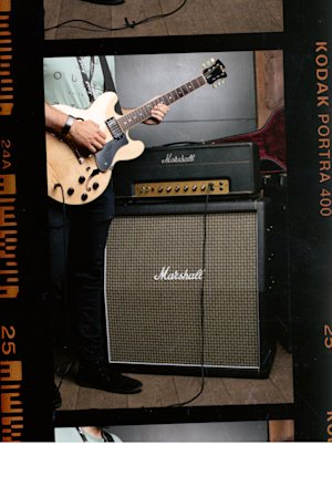 JTM45 2245 Head connected to a guitar and turning the knobs