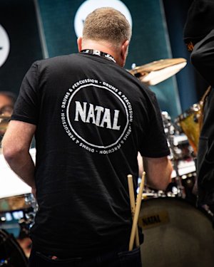 People surrounding Natal drums and equipment.