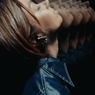 Woman wearing her Marshall Minor IV Black true wireless earbuds.