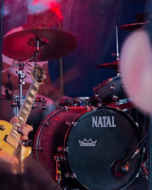 Guitarist in front of a natal drum kit