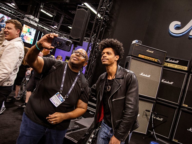 Zach Person posing with a participant of NAMM