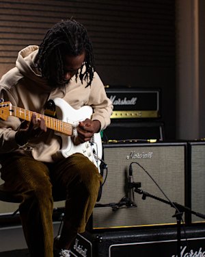 Marshall Origin50 Combo amp being played by guitarist with a white guitar