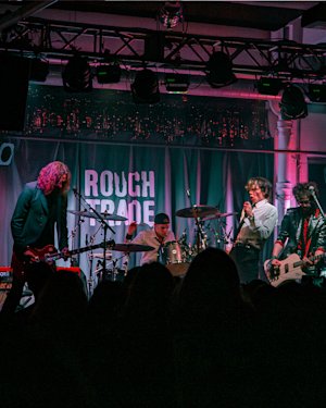A Rough Trade concert happening in a small venue