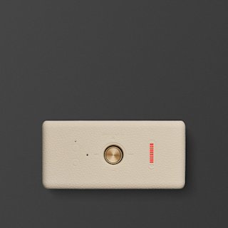 A Marshall Emberton III portable speaker in cream with a brass control button, and a red LED indicator bar on a dark gray background.